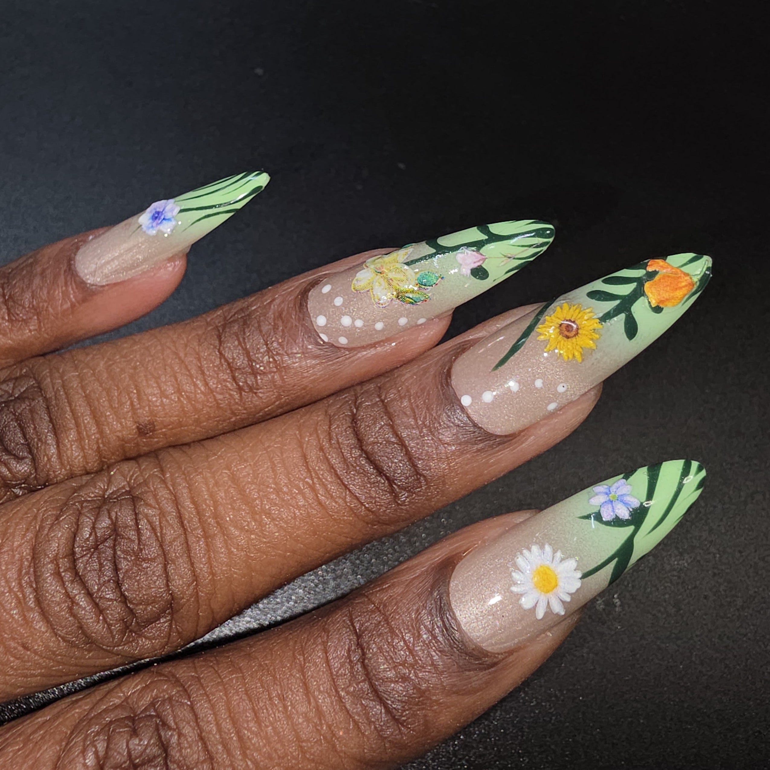 Nails with floral designs on a dark background